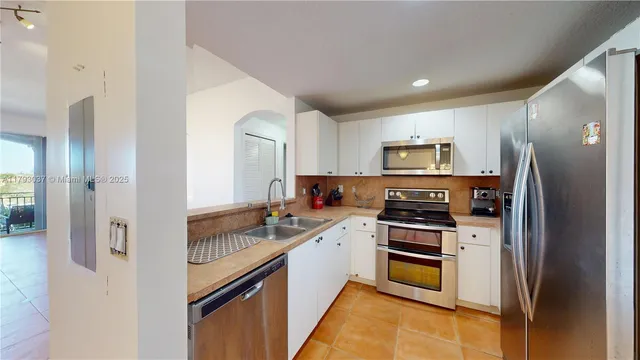 a bedroom with a bed and a view of kitchen