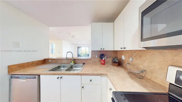 a bathroom with a sink a toilet and shower curtain