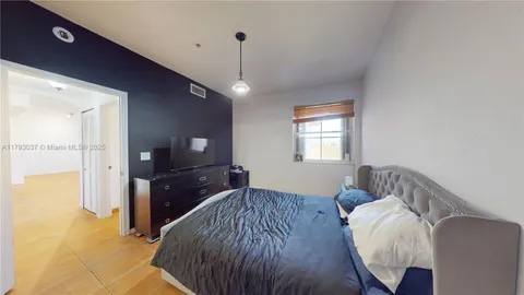 a view of a hallway with wooden floor and closet