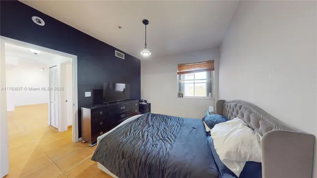 a view of a hallway with wooden floor and closet
