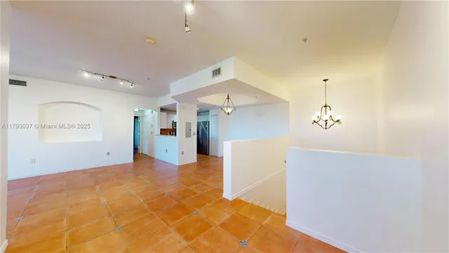 a view of a kitchen with a sink and a refrigerator