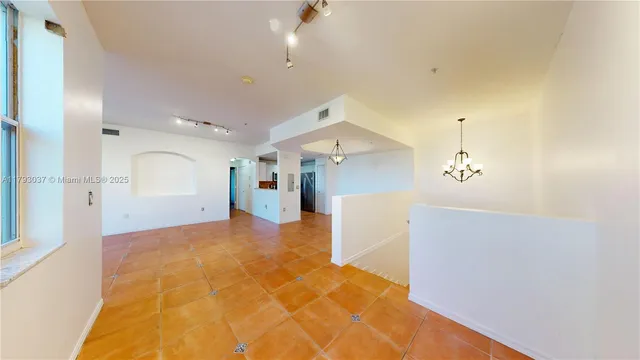 a view of a room with a kitchen