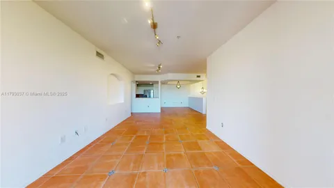 a view of an empty room with glass door