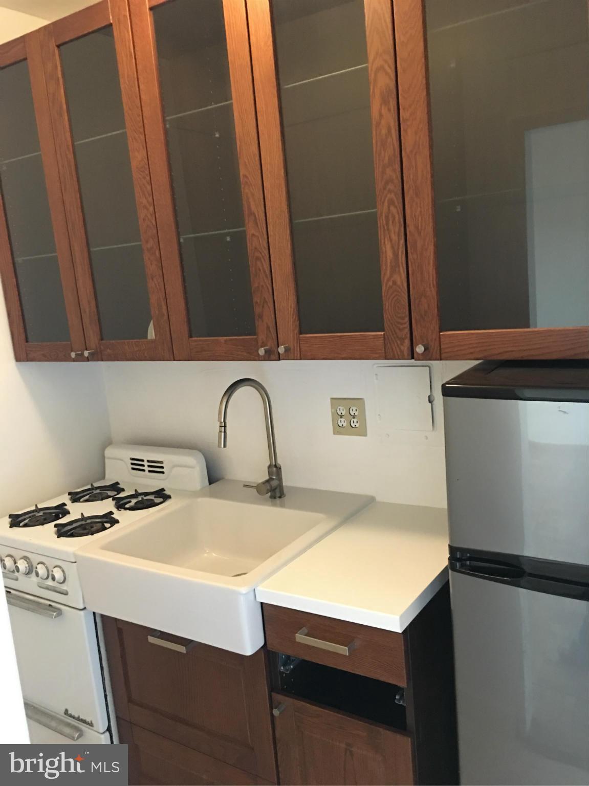 1 Scott Circle Northwest, Unit 510 Washington, DC 20005 - Photo 6 of 14 a kitchen with a sink a stove and a microwave