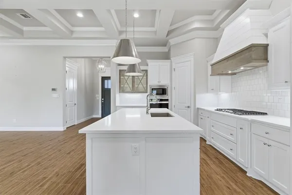 a kitchen with stainless steel appliances a refrigerator and a stove