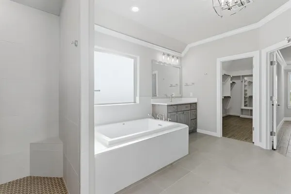 a bathroom with a tub shower and sink