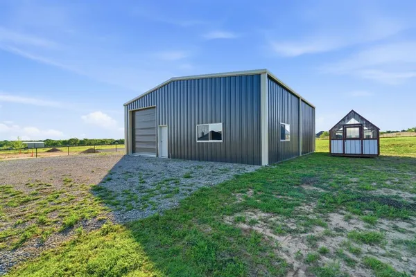 a view of a house with backyard and lake view