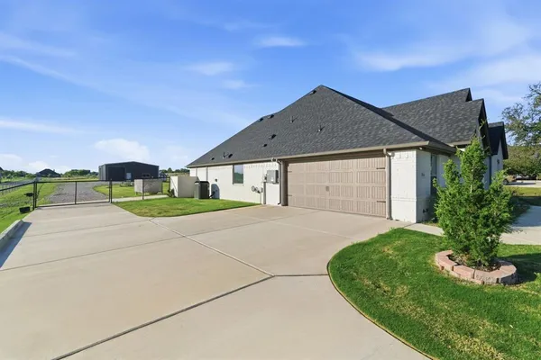 a view of a house with a yard and garage