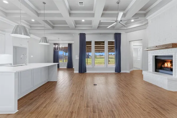 a view of an empty room with a fireplace and a window