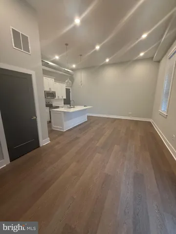 a view of a kitchen with refrigerator and window