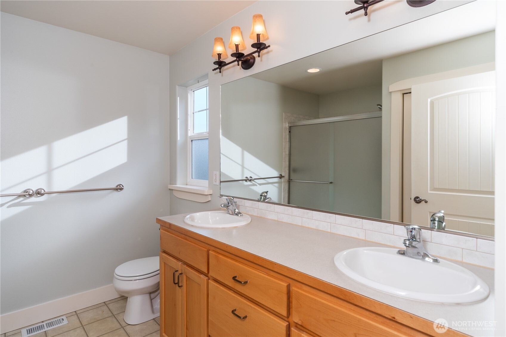 31 Pete's Spur Port Hadlock, WA 98339 - Photo 14 of 31 a bathroom with a double vanity sink toilet and a mirror