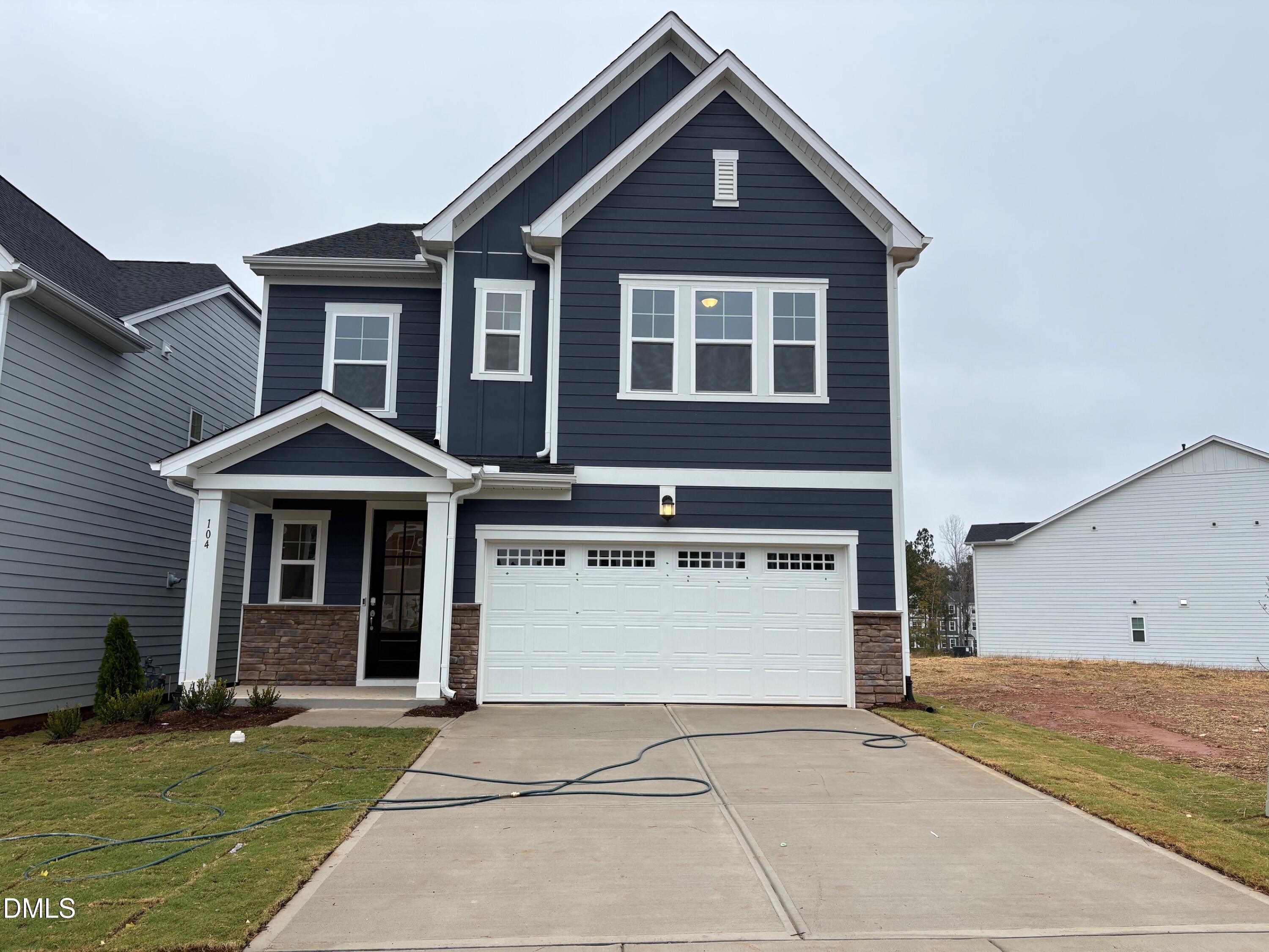 104 Corapeake Way Apex, NC 27539 - Photo 1 of 27 a front view of a house with a yard and garage