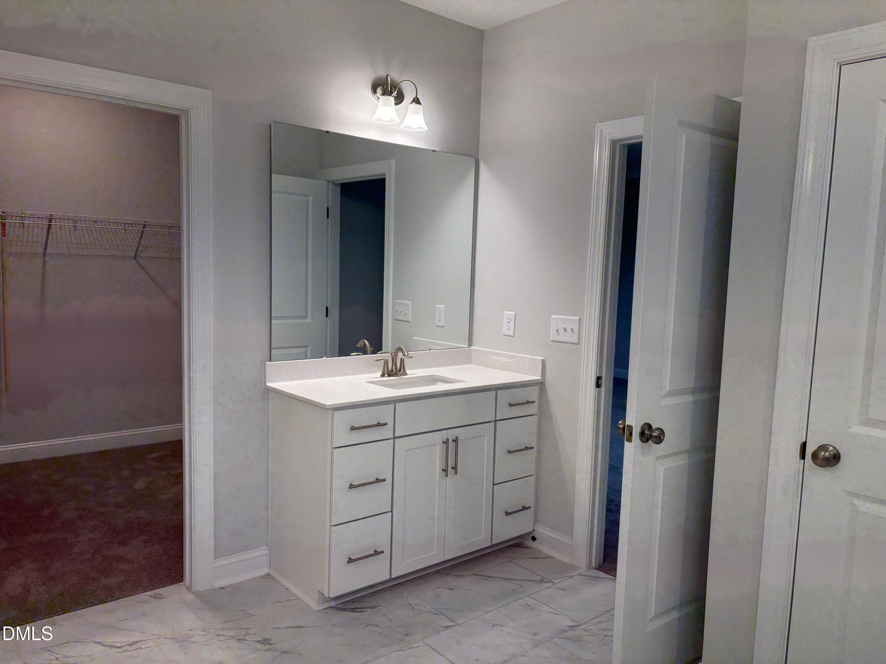 104 Corapeake Way Apex, NC 27539 - Photo 15 of 27 a bathroom with a double vanity sink and mirror