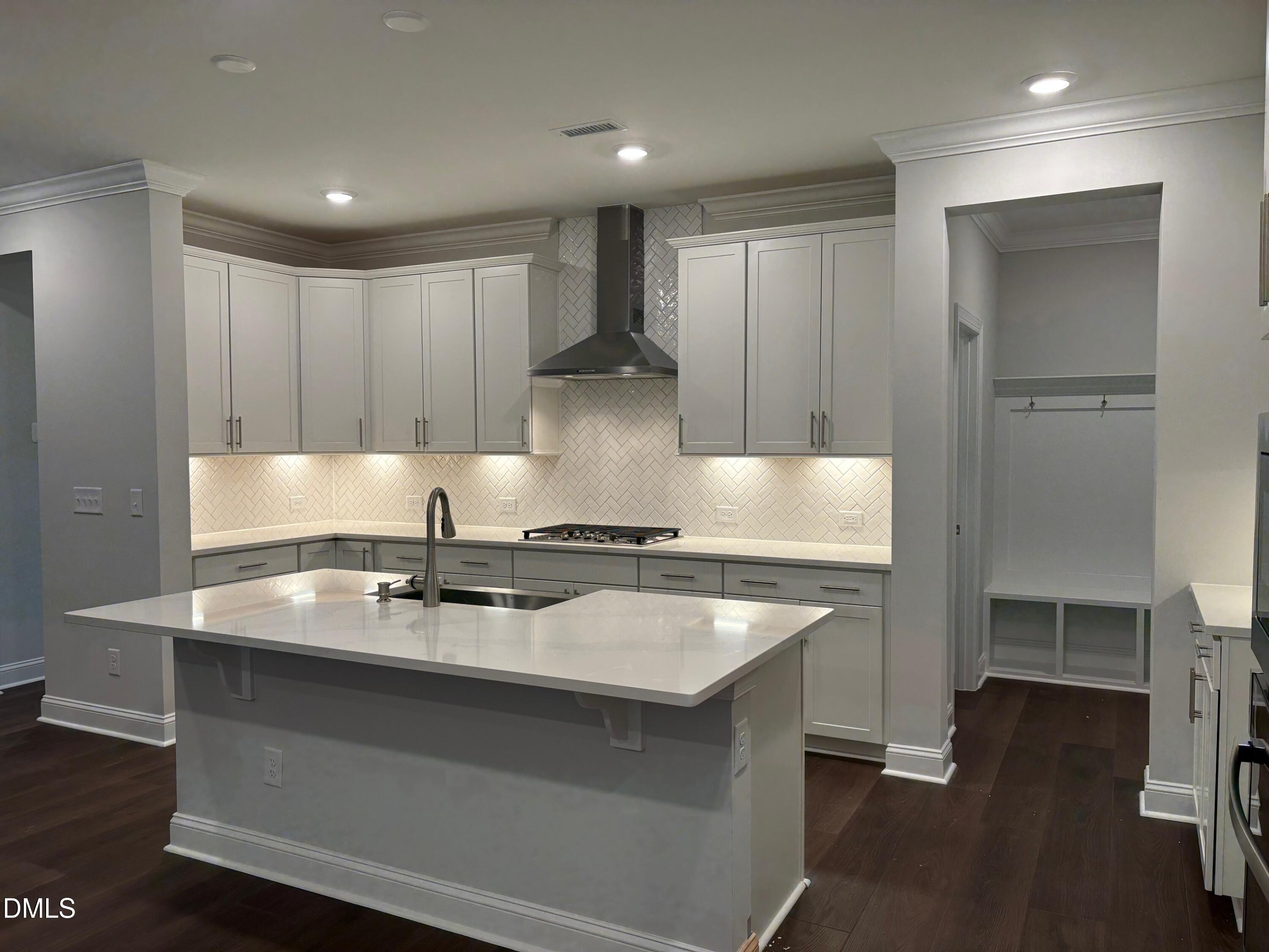 104 Corapeake Way Apex, NC 27539 - Photo 3 of 27 a kitchen with a sink stove and cabinets