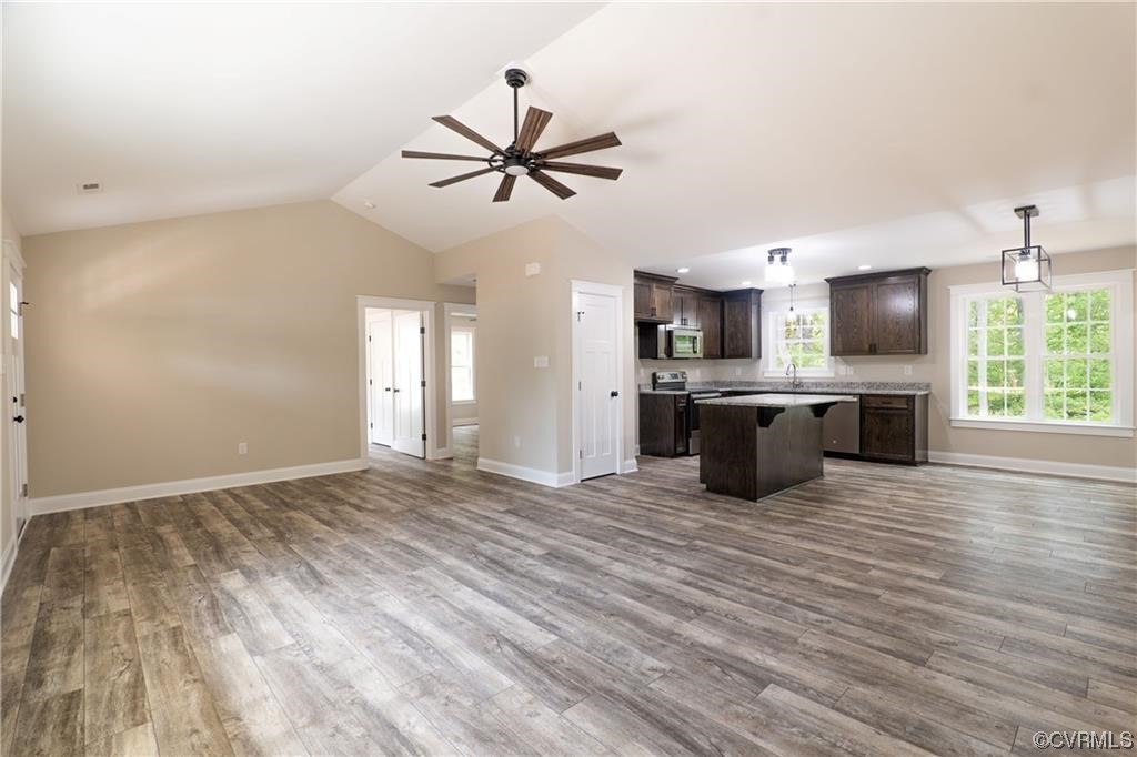 0 Howerton Road Dunnsville, VA 22454 - Photo 3 of 11 a view of a kitchen with a sink and cabinet wooden floor a chandelier