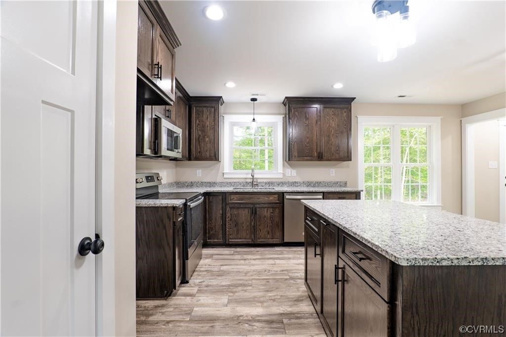 0 Howerton Road Dunnsville, VA 22454 - Photo 5 of 11 a kitchen with a sink stove and cabinets