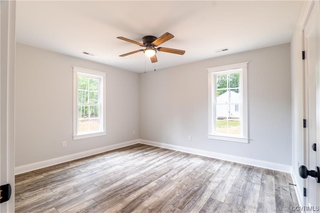 0 Howerton Road Dunnsville, VA 22454 - Photo 6 of 11 a view of an empty room with wooden floor and a window