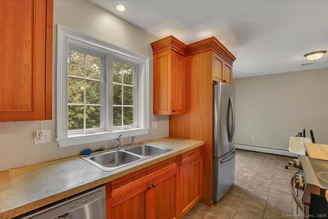 a kitchen with stainless steel appliances granite countertop a refrigerator and a sink