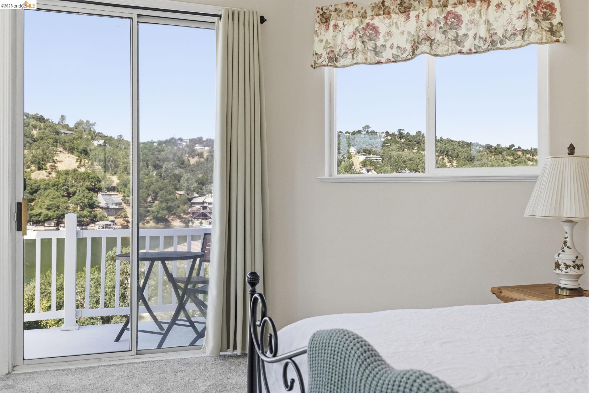 6242 Bluff View Road Copperopolis, CA 95228 - Photo 33 of 59 Sliding glass doors opening to a private balcony with a white railing