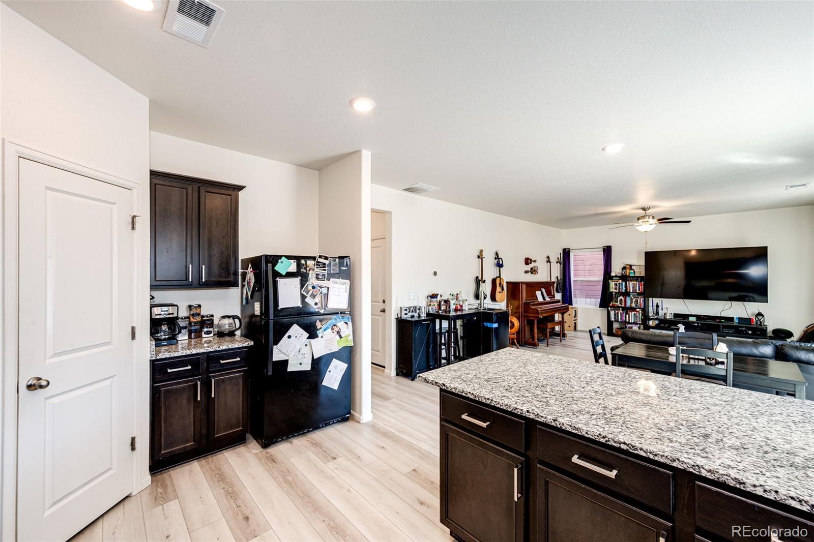 325 Walnut Street Bennett, CO 80102 - Photo 11 of 22 a kitchen with lots of counter top space and stainless steel appliances