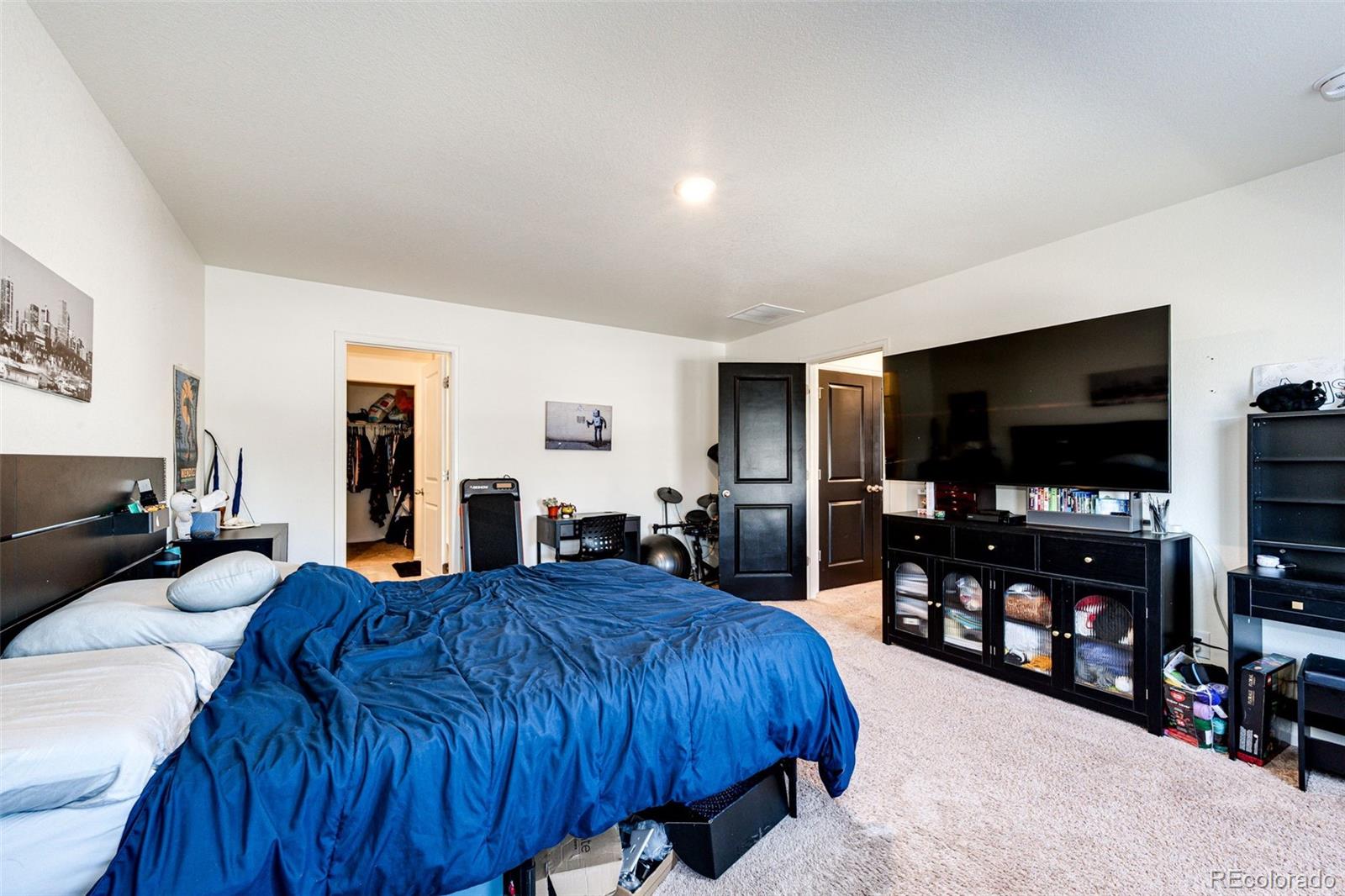 325 Walnut Street Bennett, CO 80102 - Photo 16 of 22 a living room with furniture and a flat screen tv