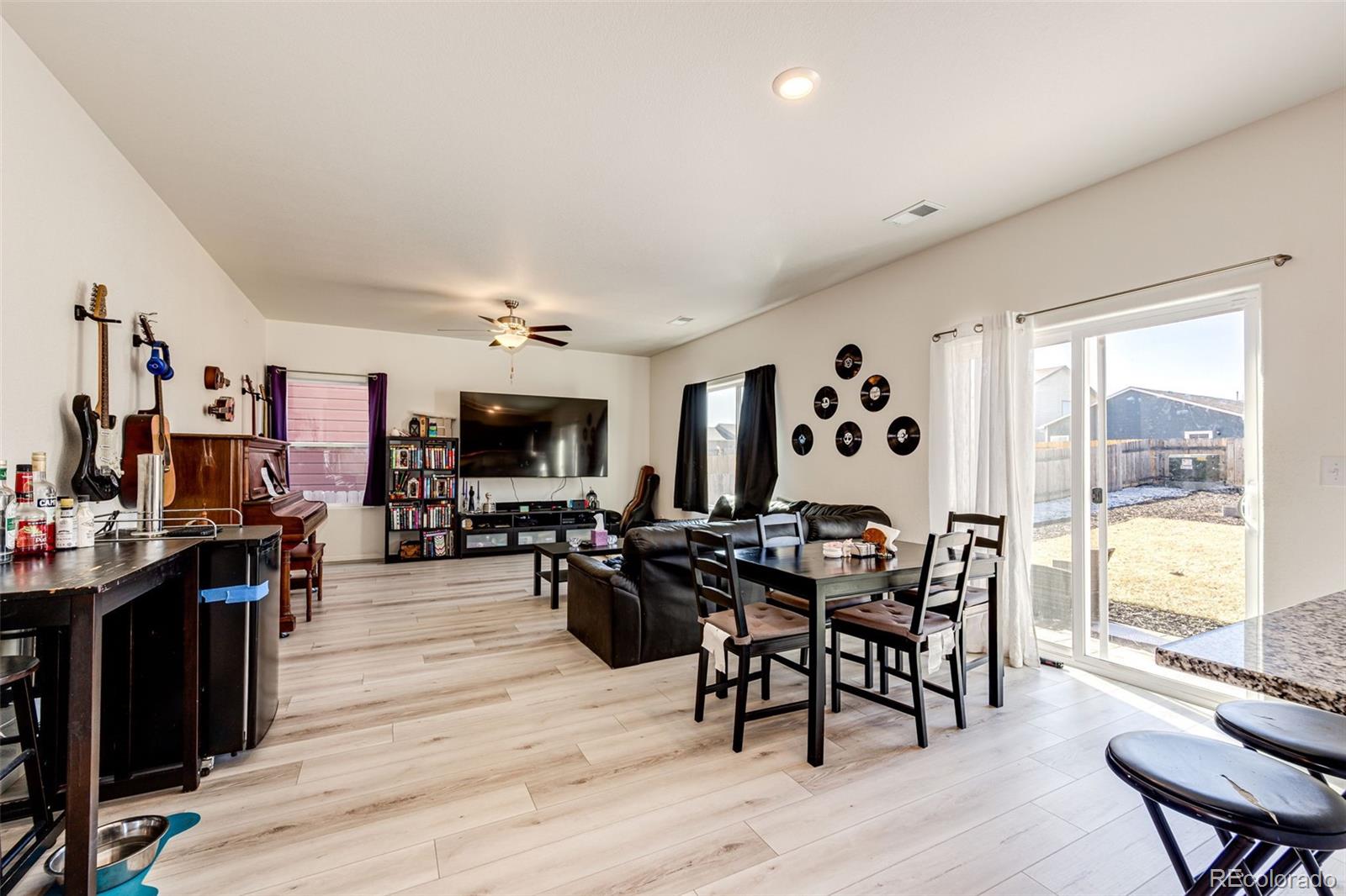 325 Walnut Street Bennett, CO 80102 - Photo 5 of 22 a view of a dining room with furniture window and wooden floor