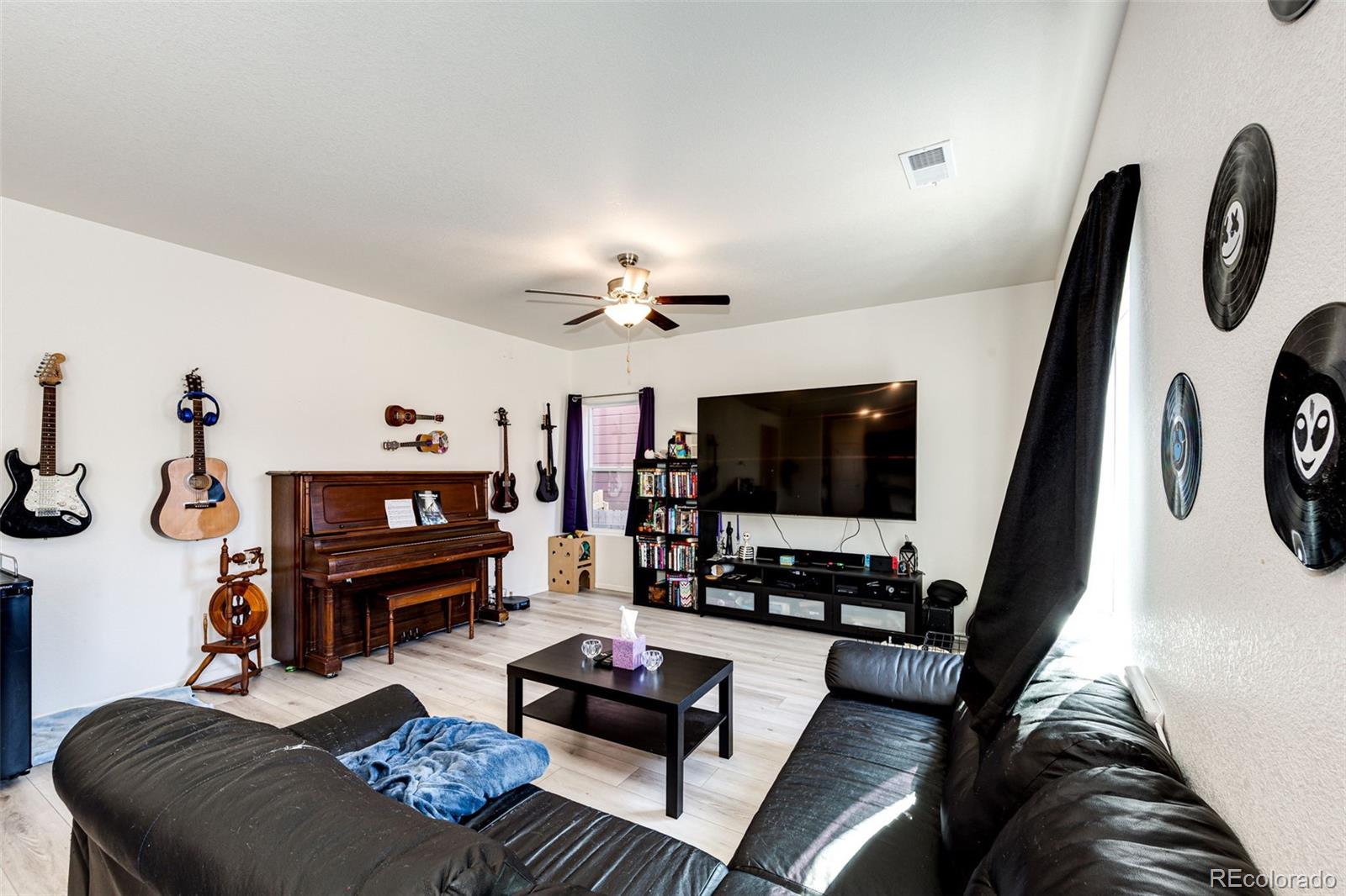 325 Walnut Street Bennett, CO 80102 - Photo 6 of 22 a living room with furniture and a flat screen tv