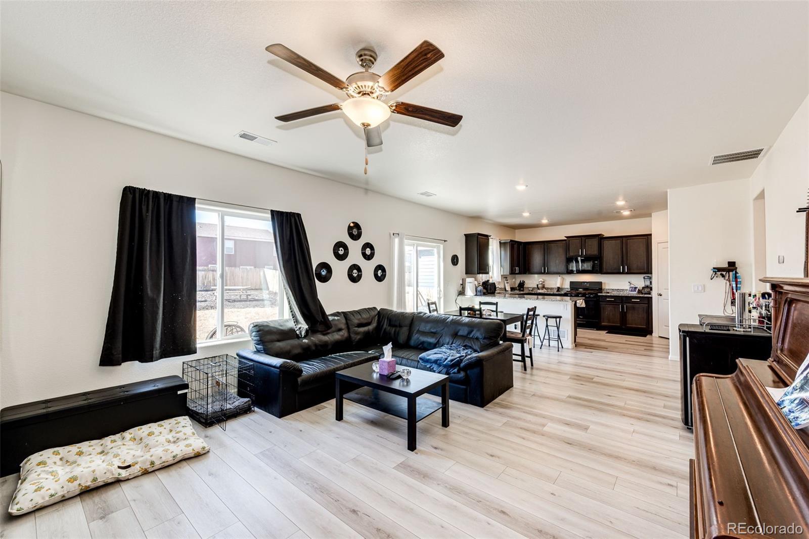 325 Walnut Street Bennett, CO 80102 - Photo 7 of 22 a living room with furniture and a large window