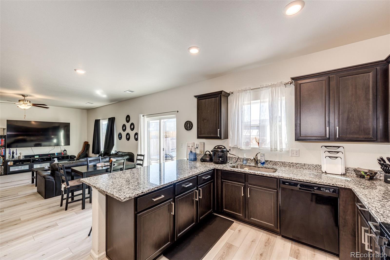 325 Walnut Street Bennett, CO 80102 - Photo 10 of 22 a kitchen with a sink stove top oven and microwave