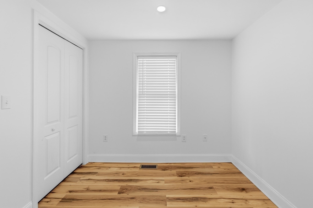 8 Cottage Street Wareham, MA 02571 - Photo 12 of 30 a view of an empty room with wooden floor and a window