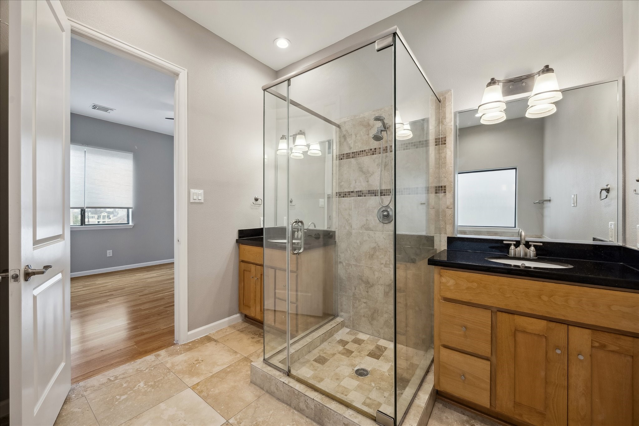 802 Waverly Street, Unit D Houston, TX 77007 - Photo 24 of 30 a spacious bathroom with a granite countertop sink mirror and shower