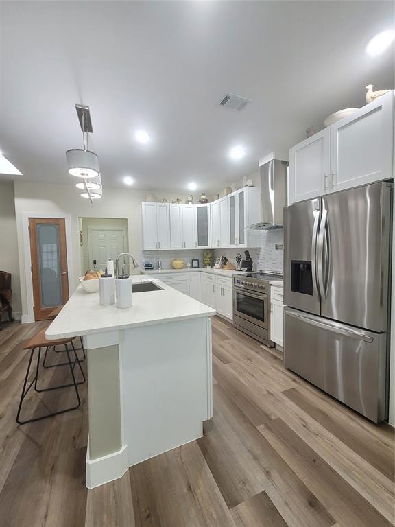 4825 Wichita Street Granbury, TX 76048 - Photo 14 of 30 a kitchen with kitchen island a sink stainless steel appliances and cabinets