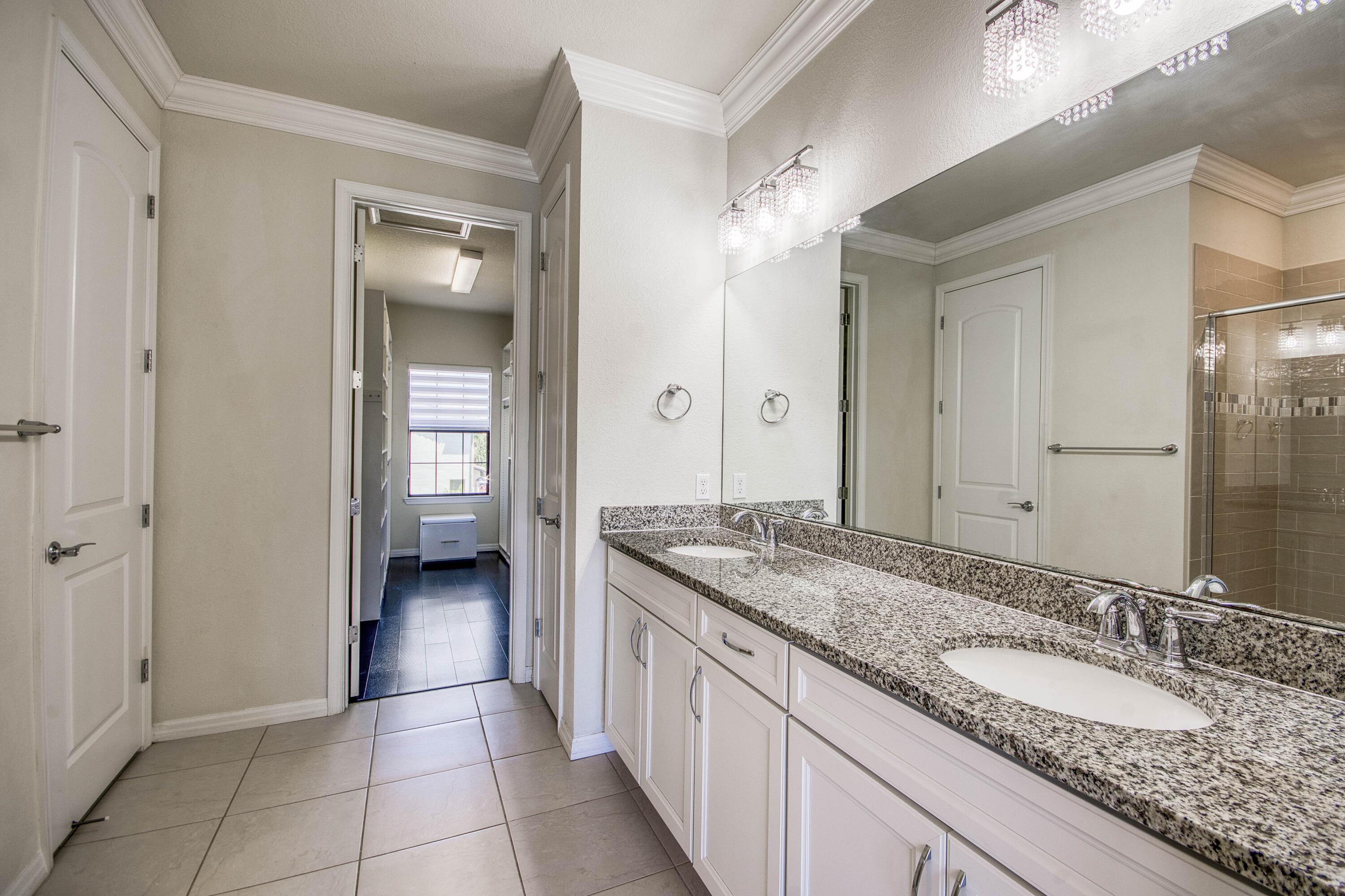 8301 Rearing Lane Lake Worth, FL 33467 - Photo 23 of 33 a spacious bathroom with a granite countertop sink and a mirror