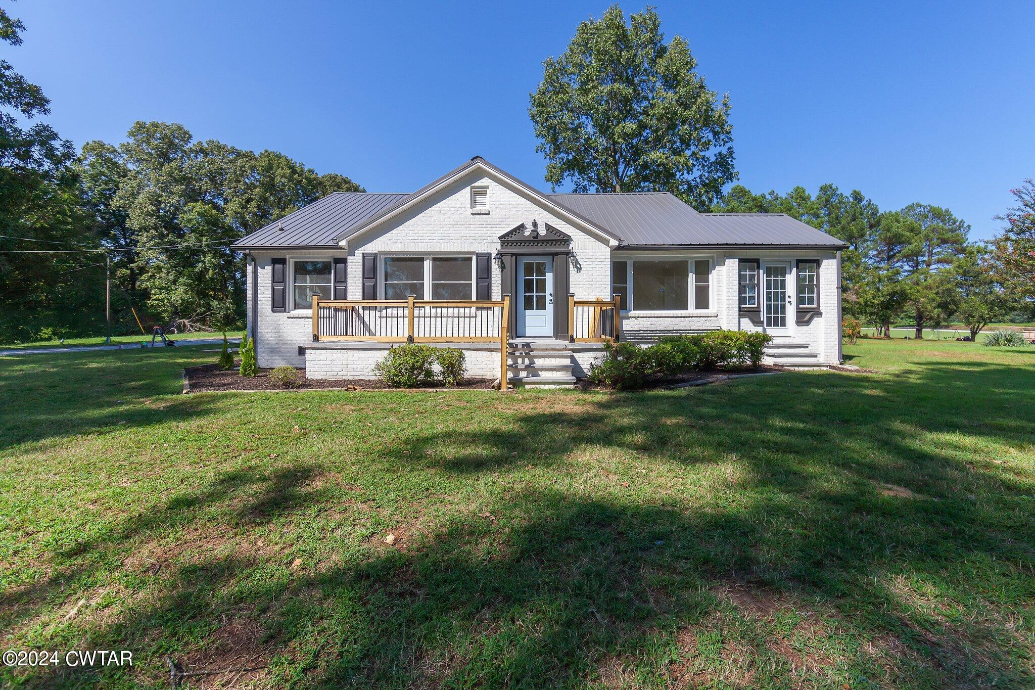 1396 Old Bells Road Jackson, TN 38305 - Photo 1 of 26 a front view of a house with a yard
