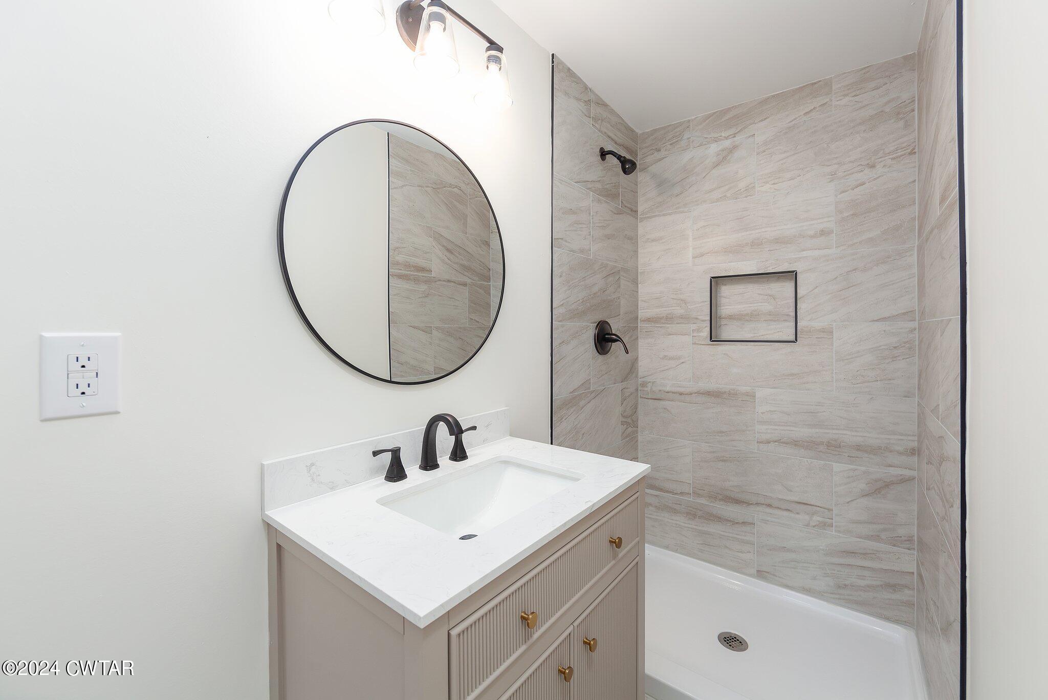 1396 Old Bells Road Jackson, TN 38305 - Photo 19 of 26 a bathroom with a sink and a mirror