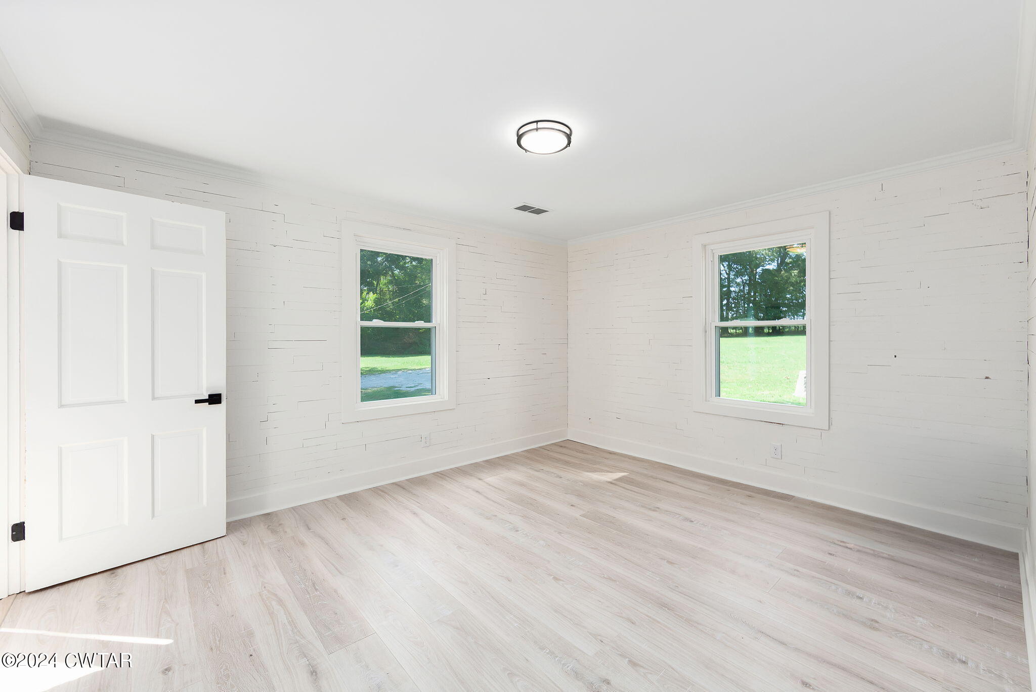 1396 Old Bells Road Jackson, TN 38305 - Photo 20 of 26 a view of an empty room with wooden floor and a window