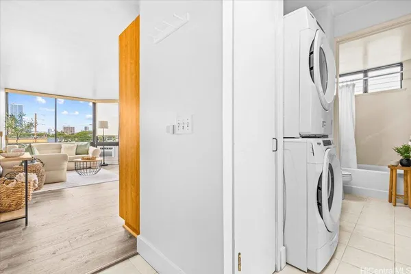 a view of a living room with a floor to ceiling window and wooden floor
