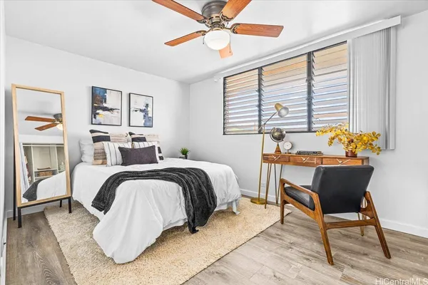 a bedroom with a bed and wooden floor