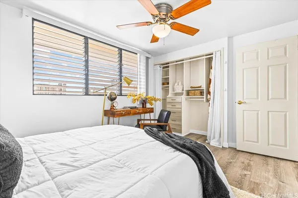 a bedroom with a bed and a window