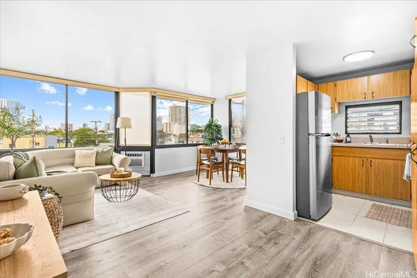 a living room with furniture and a floor to ceiling window