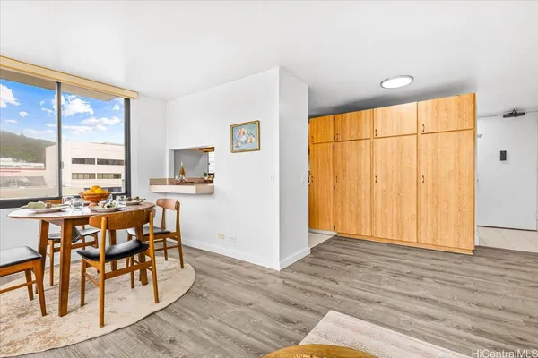 a view of a dining room with furniture window and wooden floor