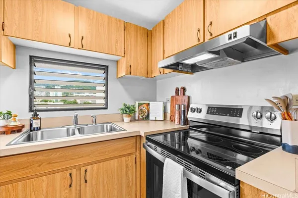 a kitchen with stainless steel appliances a sink dishwasher stove and refrigerator