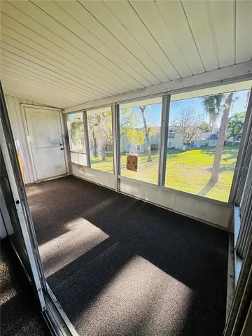 a view of an empty room and a window
