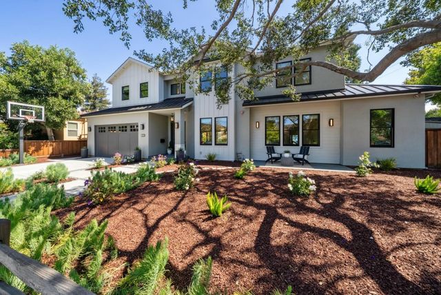a front view of a house with garden