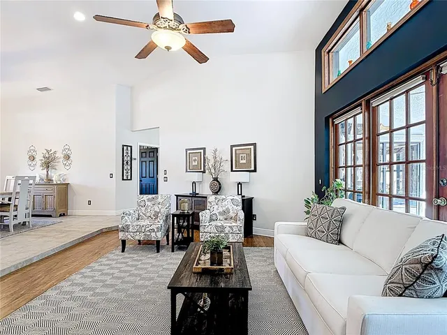a kitchen with stainless steel appliances granite countertop a sink a stove and a wooden floors