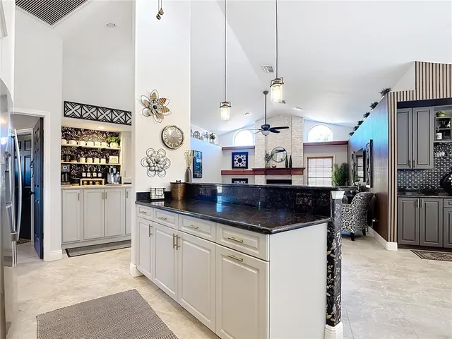 a living room with furniture a fireplace and a chandelier