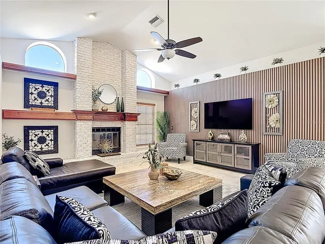 a living room with furniture a chandelier and a rug