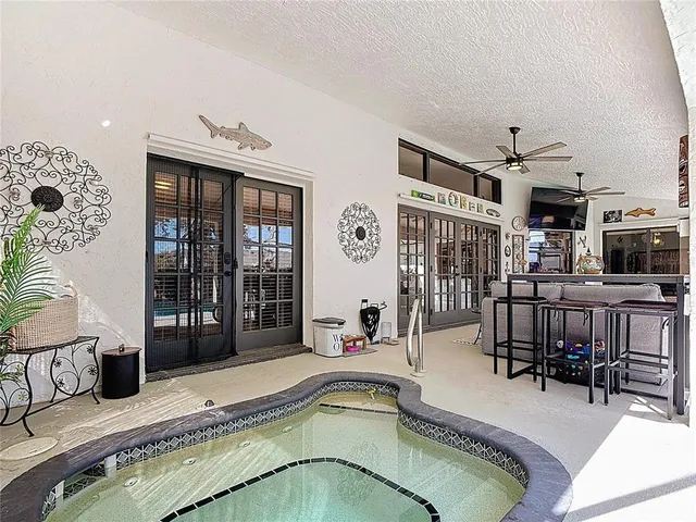 a room with a black white checkered floor with a large mirror and sink