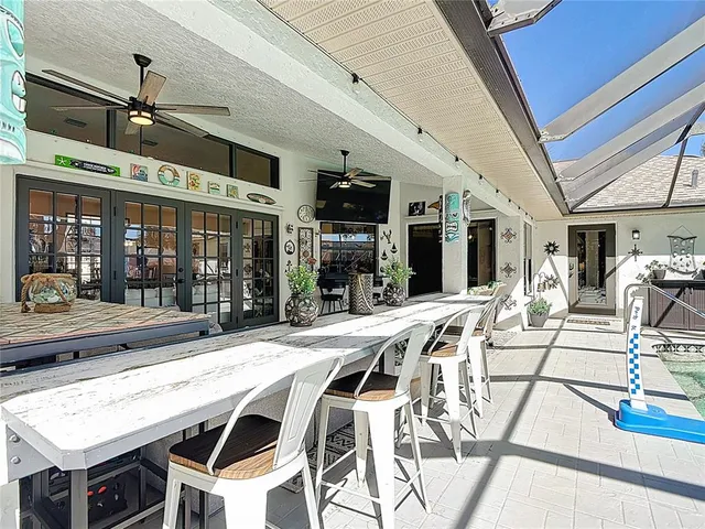 a spacious bedroom with a large bed and a chandelier