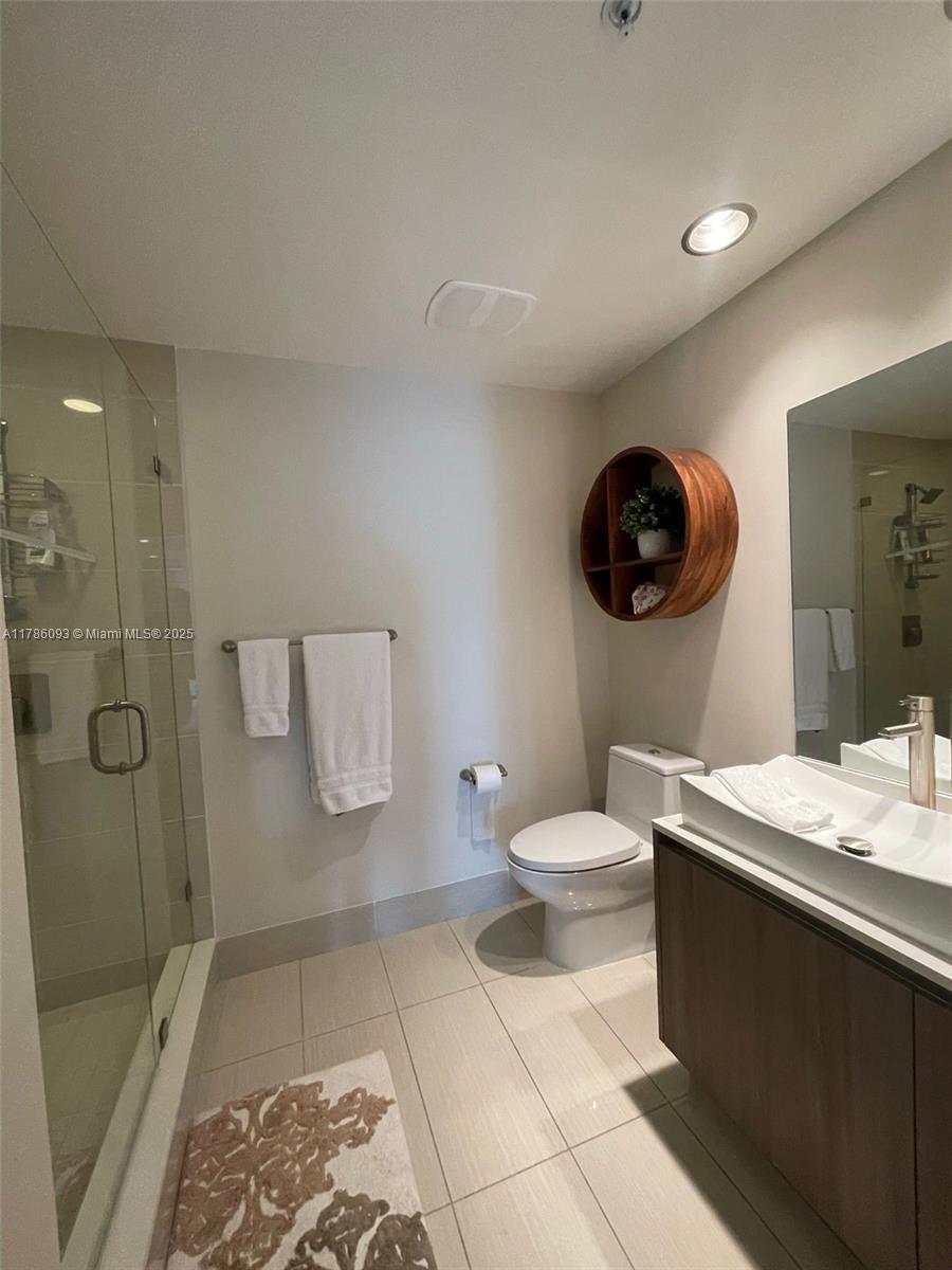 201 Southwest 17th Road, Unit 607 Miami, FL 33129 - Photo 11 of 31 a bathroom with a sink a toilet and shower